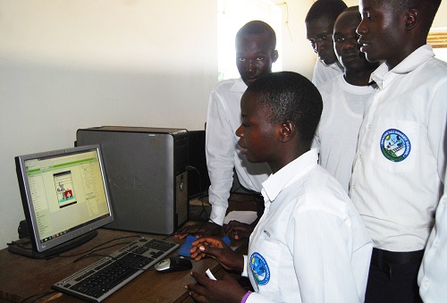 Amuge and her friends inside their computer lab illustrating how the application works )