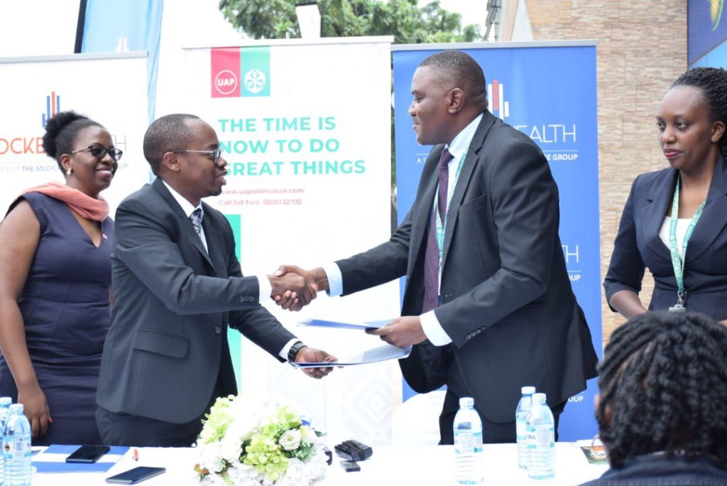 tmcg boss and uap director shaking hands